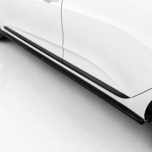 White SUV with black side running board along the lower body, wheel visible on the left side and tire on the right edge.