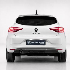 Rear view of a white Renault Clio in a studio, with illuminated red taillights and a Motordome Design license plate plate visible on the bumper (centered).