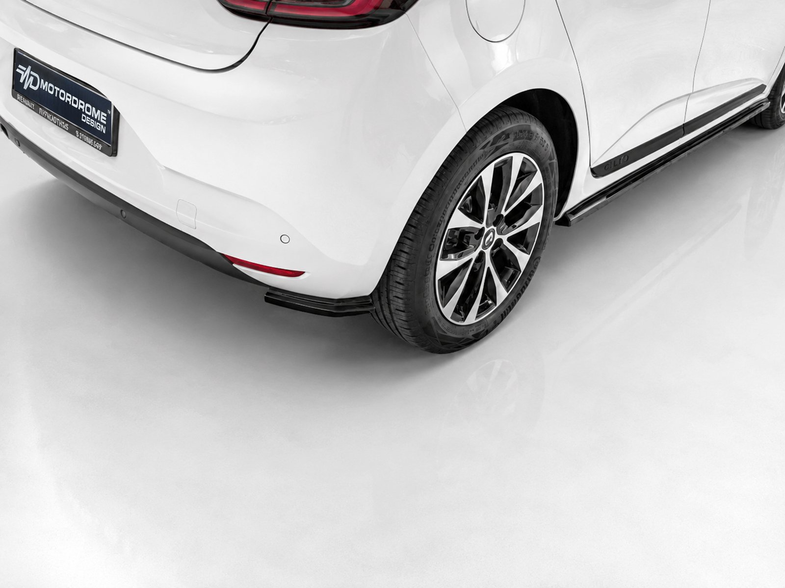 K175-004_1jpg - OPSHOLDERS White car rear quarter with alloy wheel, taillight, and lower bumper details
