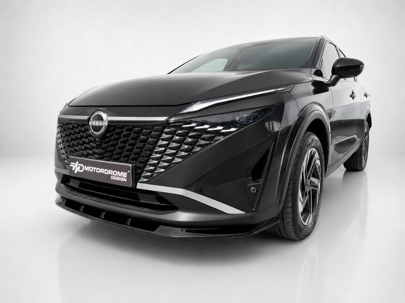 Three-quarter front view of a black Nissan SUV in a studio, highlighting the intricate diamond grille and chrome accents.