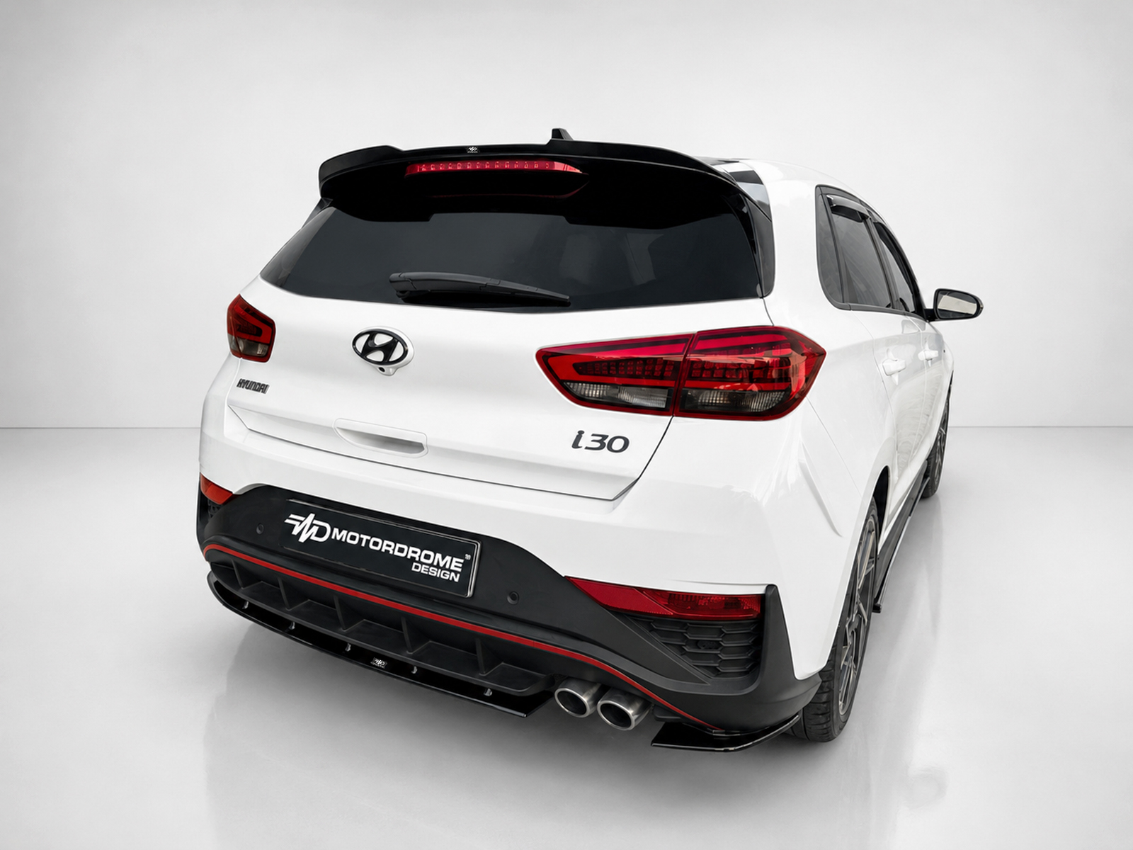 K180-002_2jpg - OPSHOLDERS Rear-right three-quarter view of a white Hyundai i30 hatchback with dark windows and red taillights in a studio setting.