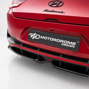 K180-005_4jpg - OPSHOLDERS Rear view of a red Hyundai Fastback with a black license-plate reading 'MotorDome Design' and Hyundai emblem above it.