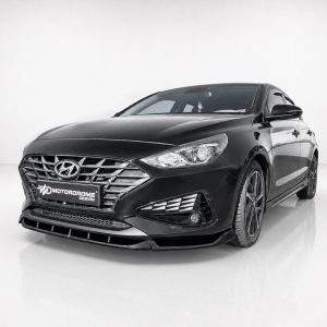 Black Hyundai sedan, front-left angle, in a white studio setting with a chrome grille and glossy finish