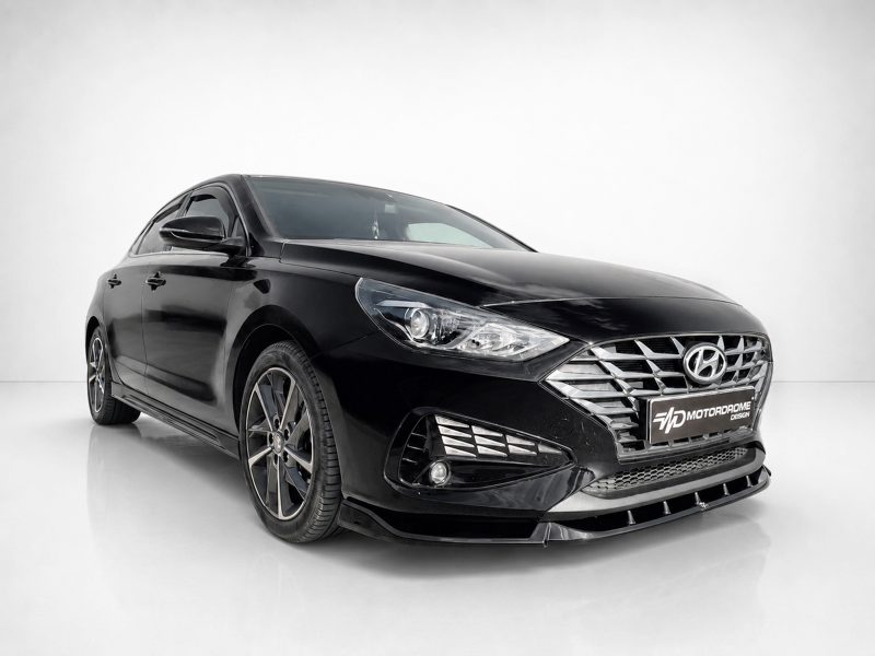 Black Hyundai sedan in a clean studio setting, front-right angle showing chrome grille and stylish headlights