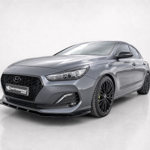 Grey Hyundai sedan shown in a studio setting with black alloy wheels and a front grille, facing left.