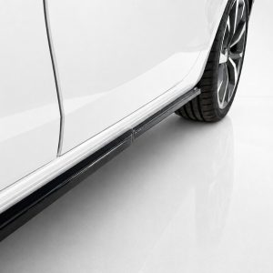 Close-up of a white car's side panel with a black running board and a tire visible at the rear site edge.
