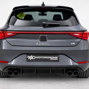 Rear view of a gray SEAT Leon FR hatchback with a continuous LED taillight, rear window and multiple exhaust tips visible at the bottom center. The 'Leon' badge sits in the middle of the trunk. A Motordrome Design plate is mounted below. A 'Baby on Board' sticker is seen on the left rear window.