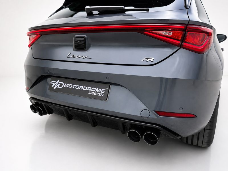 Rear view of a gray SEAT Leon FR hatchback showing the full taillight strip, badge, and quad exhausts