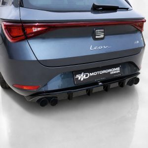 Rear view of a blue SEAT Leon FR with aftermarket Motordrome Design license plate and quad exhausts at the diffuser tail.