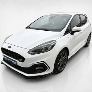 White sporty hatchback photographed in a bright studio, angled to show the front and passenger side.