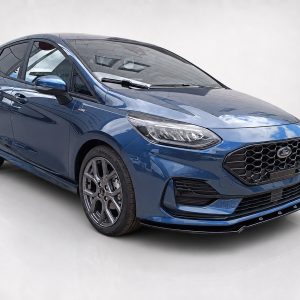 Blue Ford hatchback shown in a studio setting, front three-quarter view highlighting the honeycomb grille and alloy wheels.