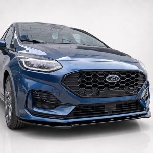 Front view of a blue Ford SUV showing its hexagonal grille and sleek headlights indoors