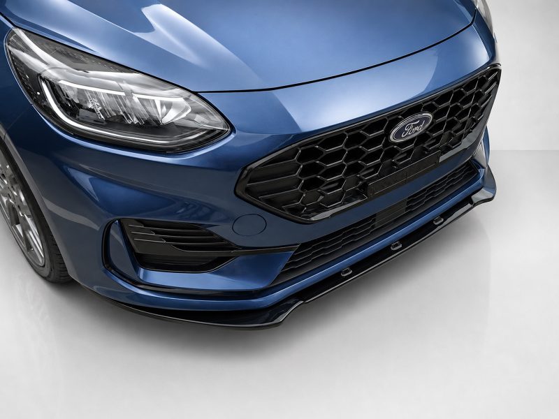 Front view of a glossy blue Ford car showing the grille and headlight.