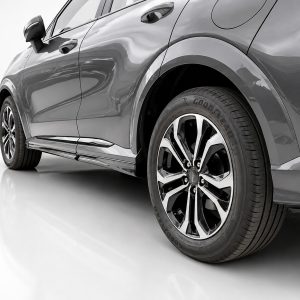 Close-up of a gray car showing the rear wheel and chrome alloy rim