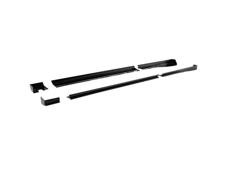 Set of black car body trim pieces laid out on a white background, separated into individual sections menacingly spaced apart.
