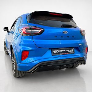 Blue Ford Puma rear view in a studio setting with "PUMA" lettering and rear badge visible