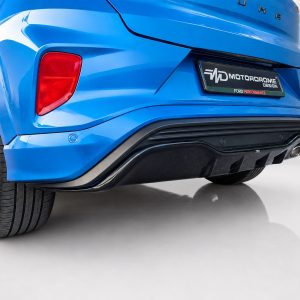 Rear view of a bright blue SUV showing the left taillight, bumper, and license plate area with a car design logo plate.