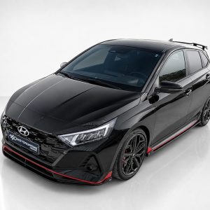 Black Hyundai sedan shown from a front-side angle with glossy finish and red accents along the lower body and grille area.