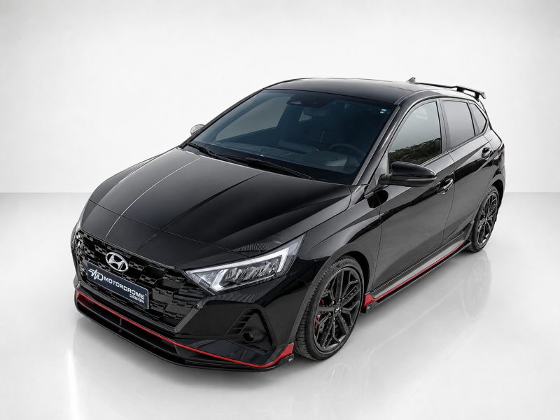 Black Hyundai sedan shown from a front-side angle with glossy finish and red accents along the lower body and grille area.