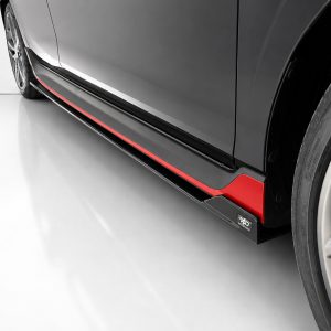 Close-up of a dark gray car's lower side panel with a red accent trim and part of the wheel visible on the right side.