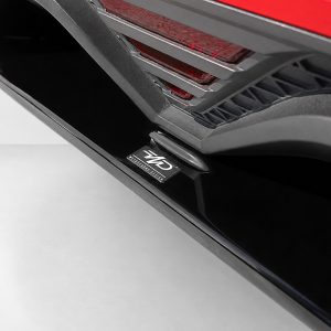 K185-003_4jpg - OPSHOLDERS Close-up of a car's door sill and lower rear bumper, showing a black step plate and a badge reading 'GKD' with 'MOTORSPORT DESIGN' text.