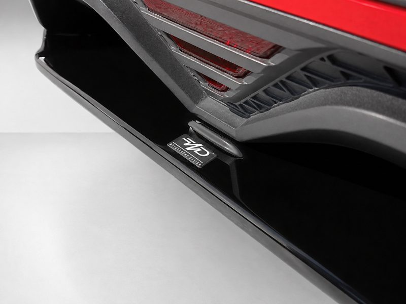 K185-003_4jpg - OPSHOLDERS Close-up of a car's door sill and lower rear bumper, showing a black step plate and a badge reading 'GKD' with 'MOTORSPORT DESIGN' text.