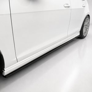 Side view of a white car with alloy wheels and a black side step visible along the lower body edge.