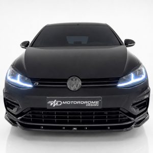 Front view of a black VW car with glowing LED headlights and a Motordrome Design plate.
