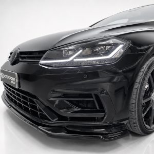 Front-left angle of a glossy black car showing the headlight, grille, and lower bumper details, with a sleek modern design.]