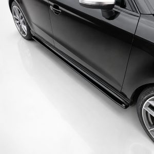 K187-002_2jpg - OPSHOLDERS Close-up of a sleek black car's lower side and alloy wheel, highlighting the side skirt and glossy finish.