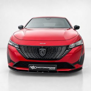 Front view of a red Peugeot 308 with a black grille and badge, set against a light gray studio background.