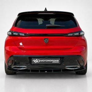 Rear view of a red Peugeot 308 hatchback in a studio, showing the tail lights, badge, and a dyed license plate reading 'MD Motorodrome Design'