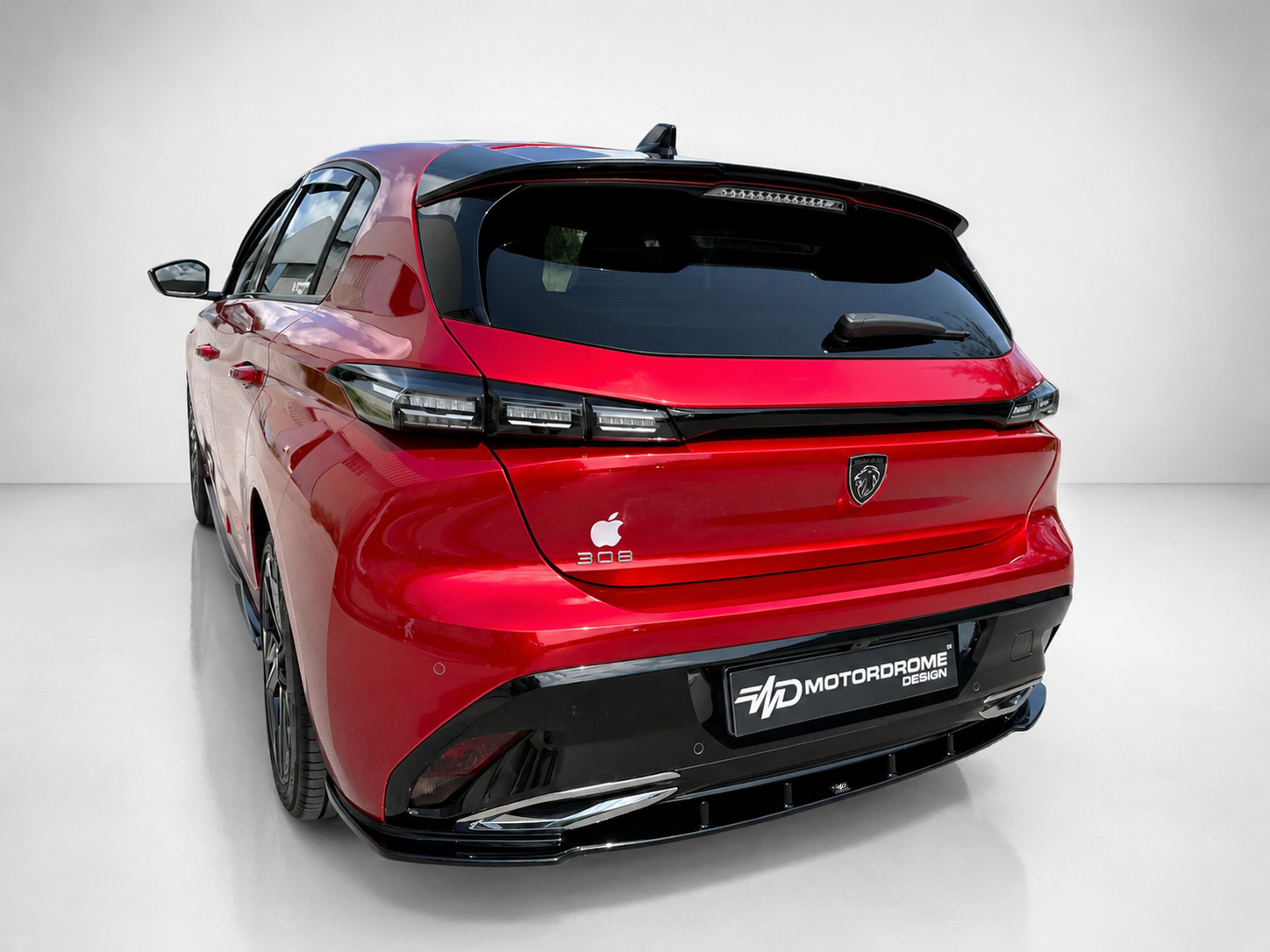 K189-003_2jpg - OPSHOLDERS Rear three-quarters view of a red Peugeot SUV in a studio, highlighting black spoiler, LED taillights, and a Motordrome Design plate.