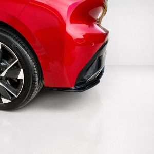 K189-003_4jpg - OPSHOLDERS Close-up of a red car's front left area showing the wheel and tire with a glossy paint finish.