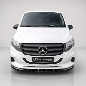 Front view of a white Mercedes van with black grille and prominent Mercedes emblem, headlights on each side, and a dealer plate reading 'MOTOR DROME DESIGN'