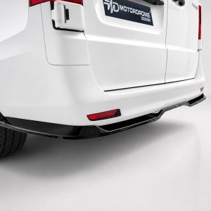 Rear view of a white van with wheel, bumper, and a Motordrome Design badge on the tailgate edge