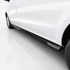 White car side view showing a black running board under the doors and visible wheel rim on the right side.