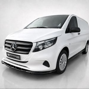 White Mercedes cargo van shown from a front-left angle in a studio setting, glossy floor and backdrop behind it.