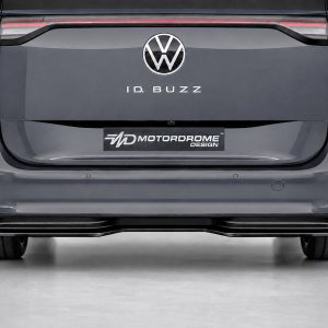 Rear view of a dark gray VW ID. BUZZ van showing the logo and 'ID. BUZZ' text on the tailgate with a 'Motordrome Design' plate below.
