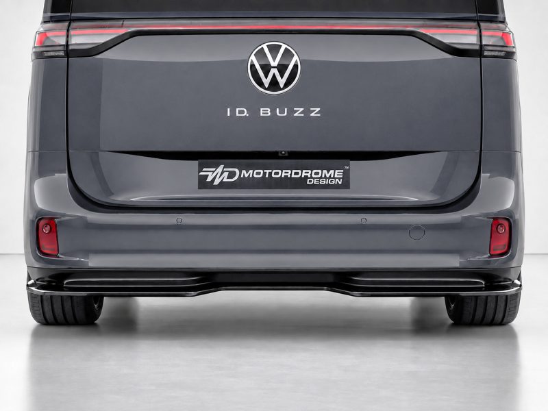 Rear view of a dark gray VW ID. BUZZ van showing the logo and 'ID. BUZZ' text on the tailgate with a 'Motordrome Design' plate below.
