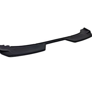 Long black plastic front bumper lip spoiler laid on a white background for a car’s aerodynamics