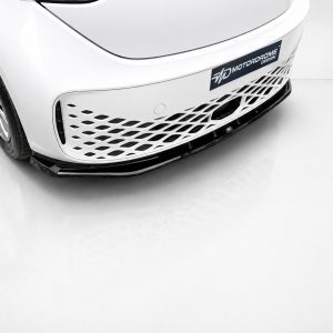 Front view of a white sports car highlighting the perforated lower grille and bumper edge.