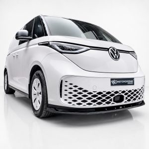 Front three-quarter view of a white concept van with VW logo and patterned lower grille in a studio setting