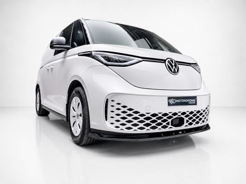 Front three-quarter view of a white concept van with VW logo and patterned lower grille in a studio setting