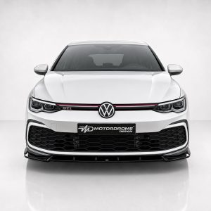 Front view of a white Volkswagen GTI with a black honeycomb grille, red accent stripe, and a center VW emblem; a MD MotorDrome Design plate is mounted on the bumper.