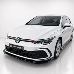 K192-001_2jpg - OPSHOLDERS Front three-quarter view of a white Volkswagen car in a studio setting, showing the VW emblem, black honeycomb grille, and red accent stripe along the grille.