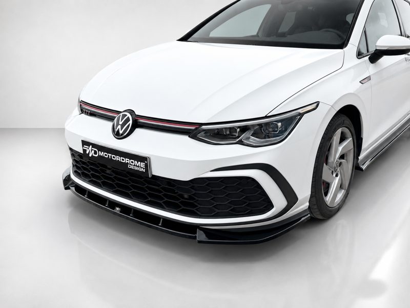 K192-001_3jpg - OPSHOLDERS Front three-quarter view of a white VW GTI with honeycomb grille in a studio setting.