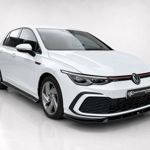 K192-001_5jpg - OPSHOLDERS White Volkswagen Golf GTI hatchback in a studio setting, featuring a sporty front bumper and honeycomb grille with a red accent stripe.