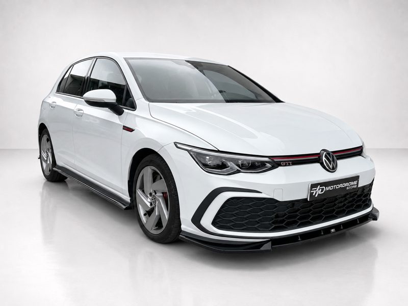 K192-001_5jpg - OPSHOLDERS White Volkswagen Golf GTI hatchback in a studio setting, featuring a sporty front bumper and honeycomb grille with a red accent stripe.