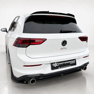 K192-004_3jpg - OPSHOLDERS White Volkswagen SUV rear view with GTI badge and aftermarket M MotorDrome plate, in a studio setting